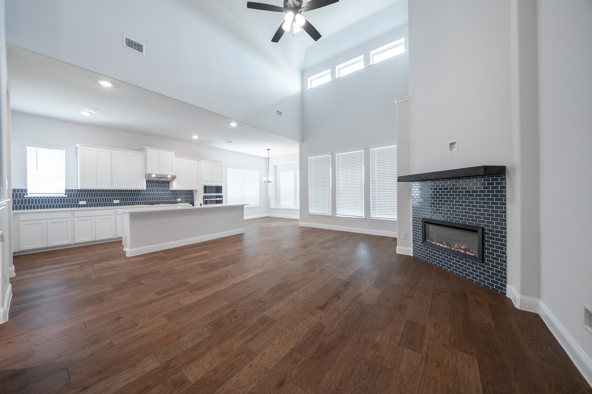 great room with high ceilings and wood flooring 