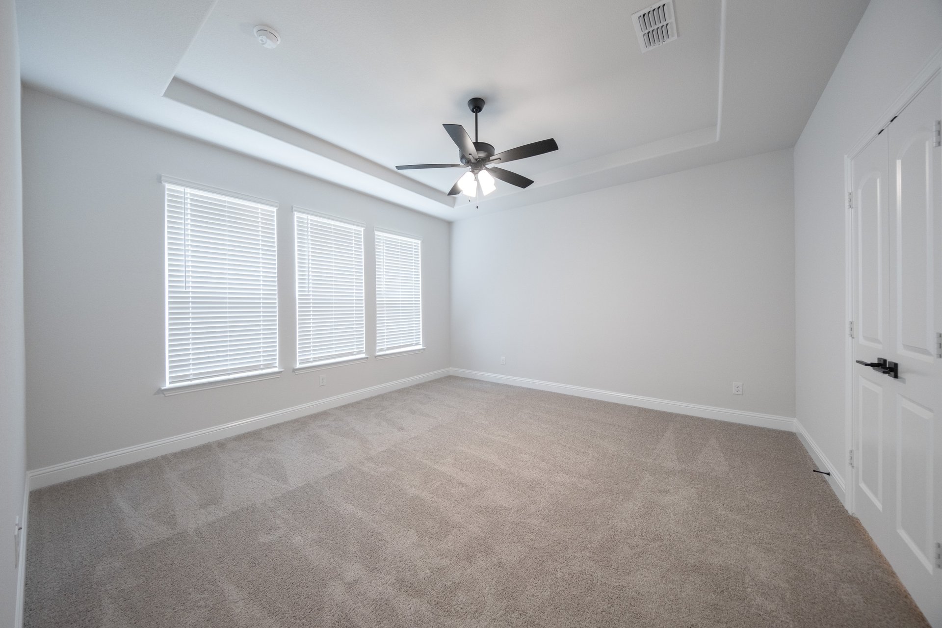 bedroom with large windows and carpet 