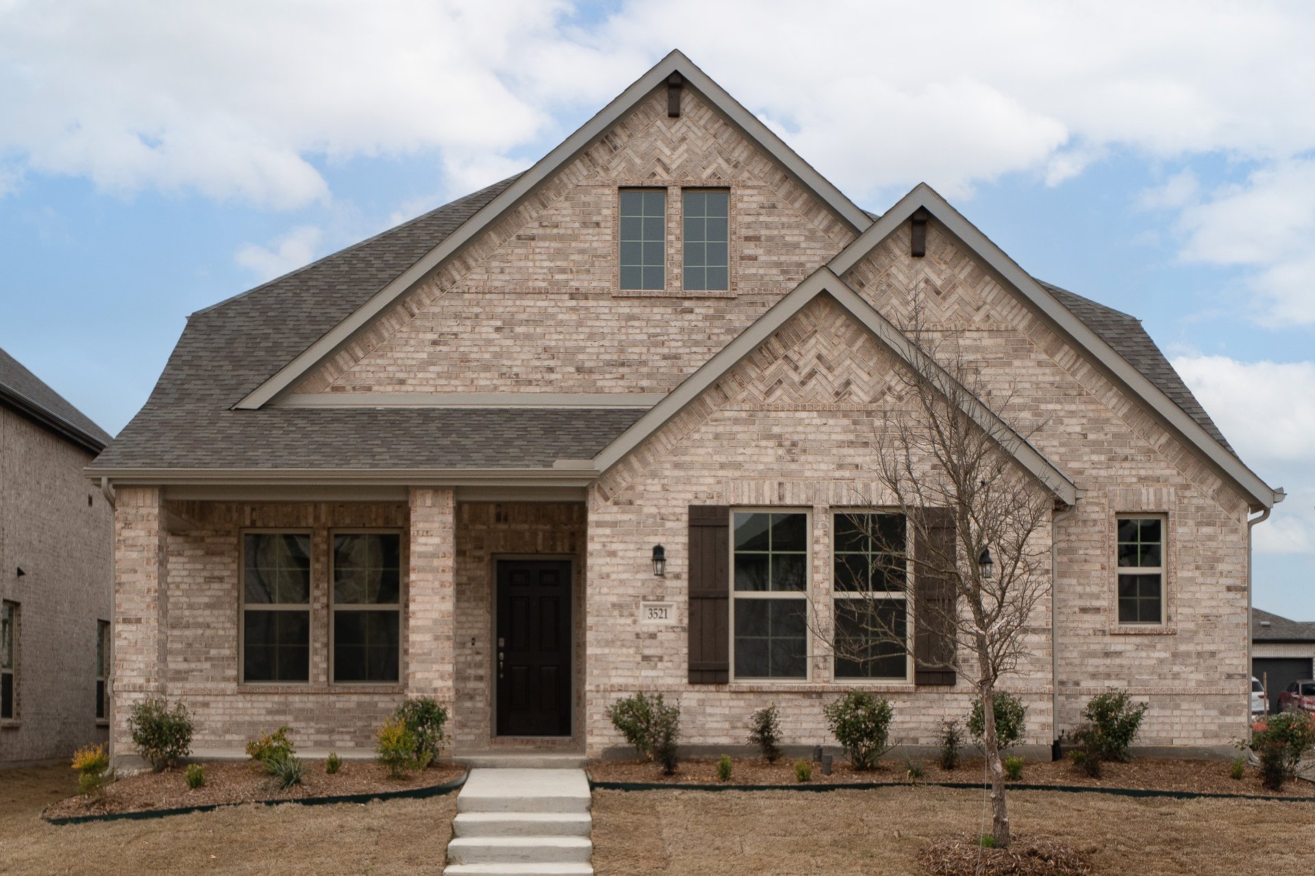 home exterior with brick and landscaping