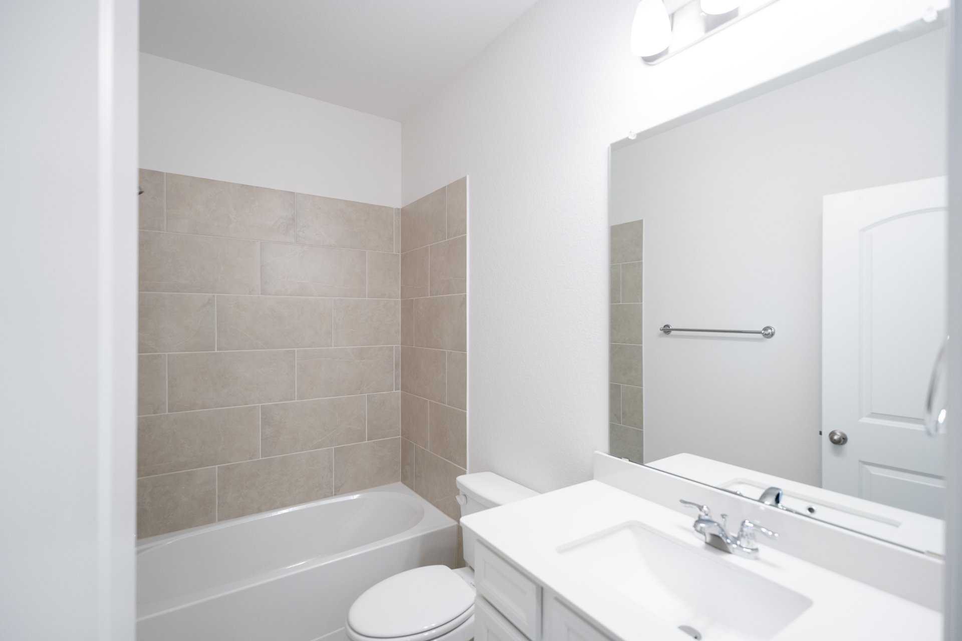 bathroom with tile and white countertops