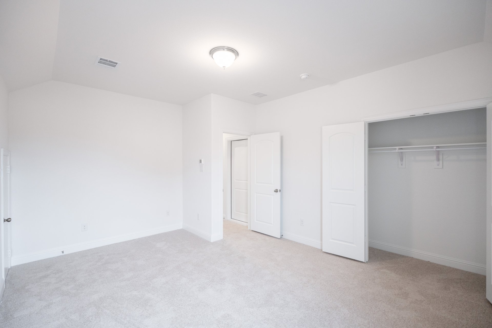 bedroom with carpet and double closet doors