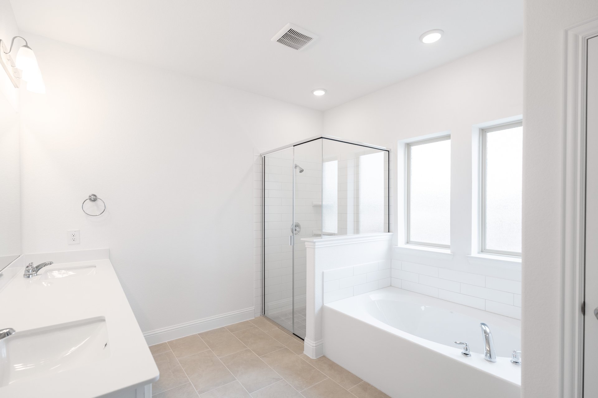 bathroom with large soaking tub and walk-in shower