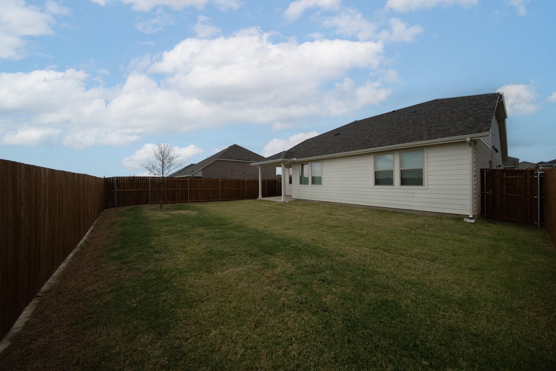 backyard with grass and covered patio