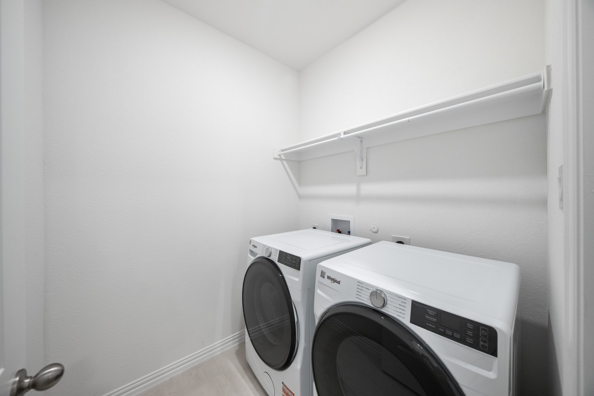 laundry room with washer, dryer, and tile floors