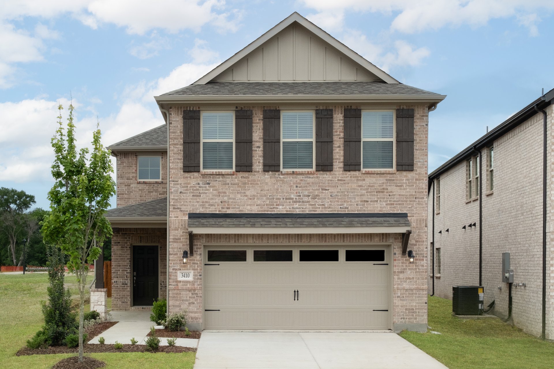 two-story home with brick and shutters