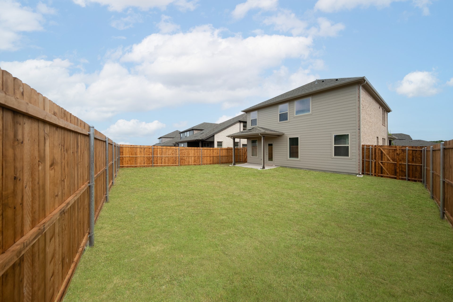 backyard with grass and covered patio