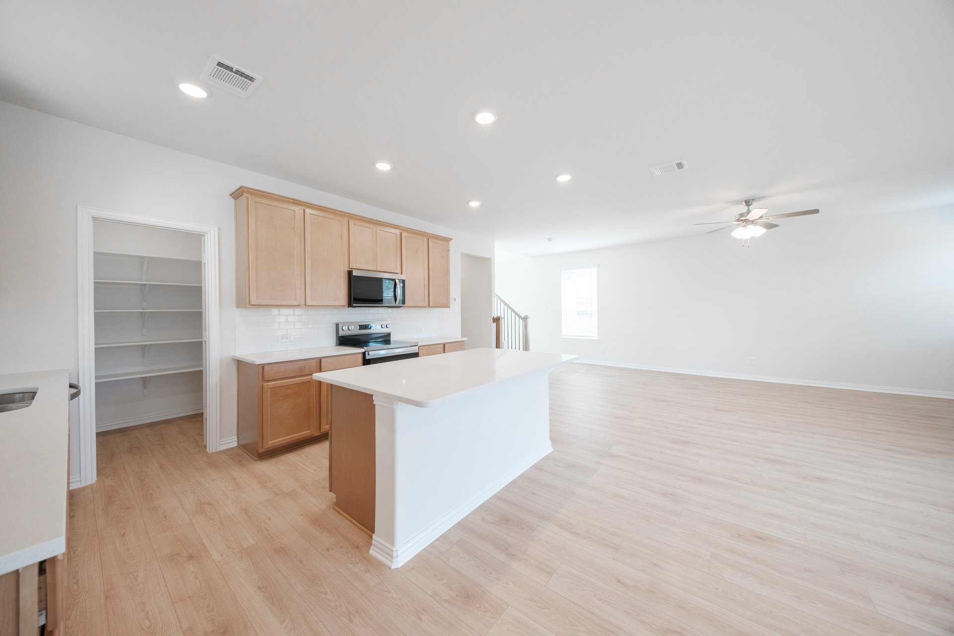 open kitchen with wood floors and island