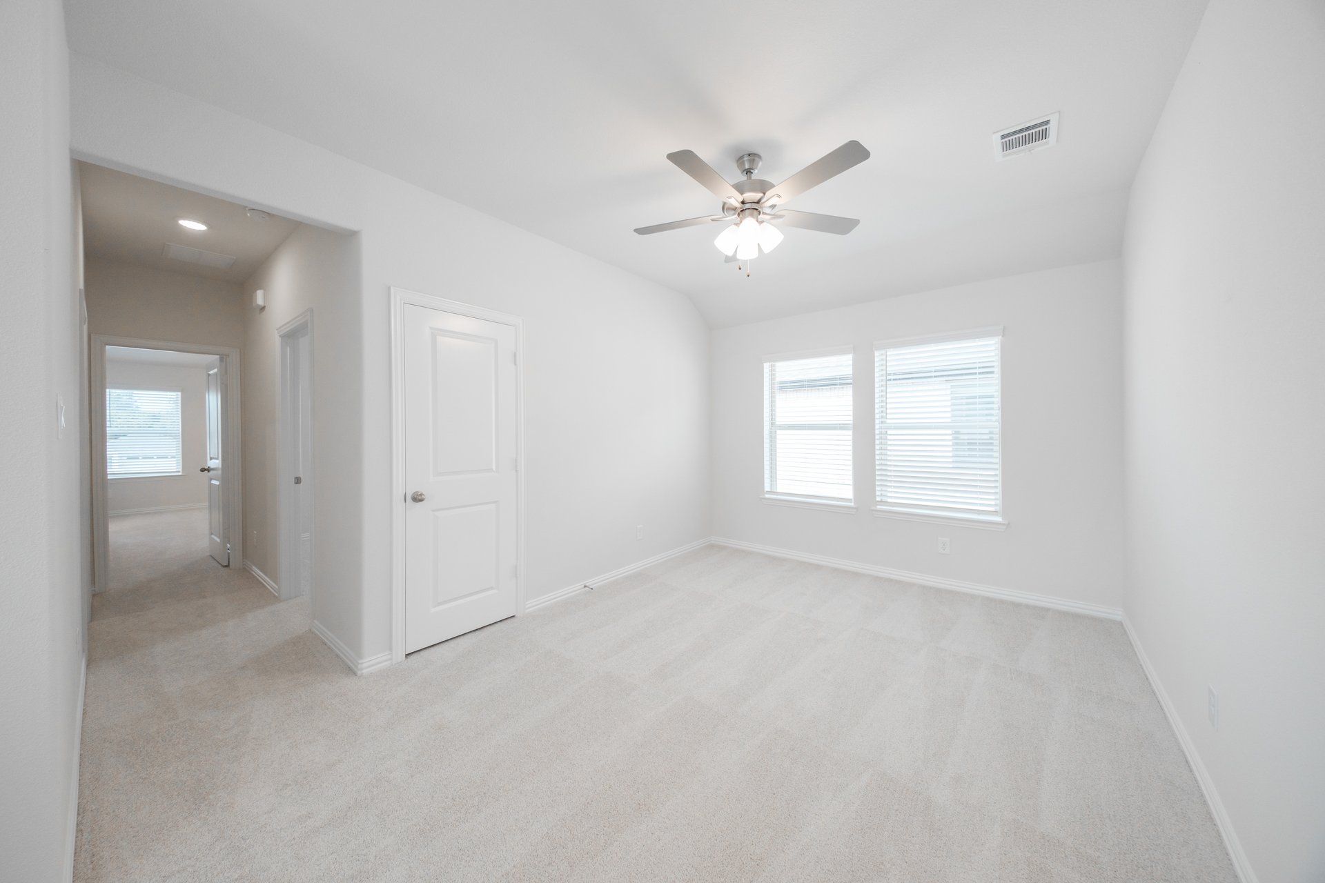 open loft with carpet and ceiling fan