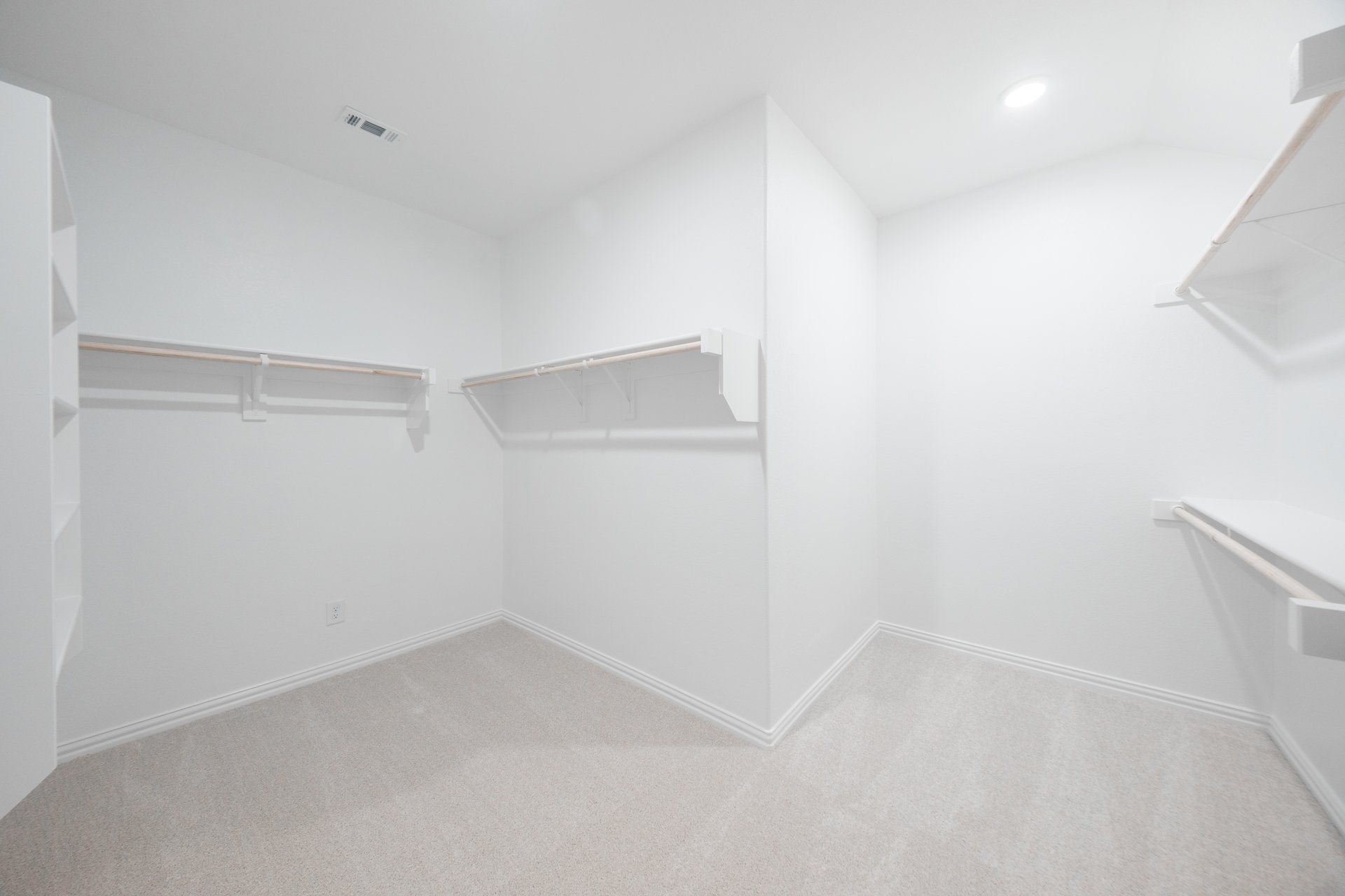 primary bedroom closet with carpet and white shelves