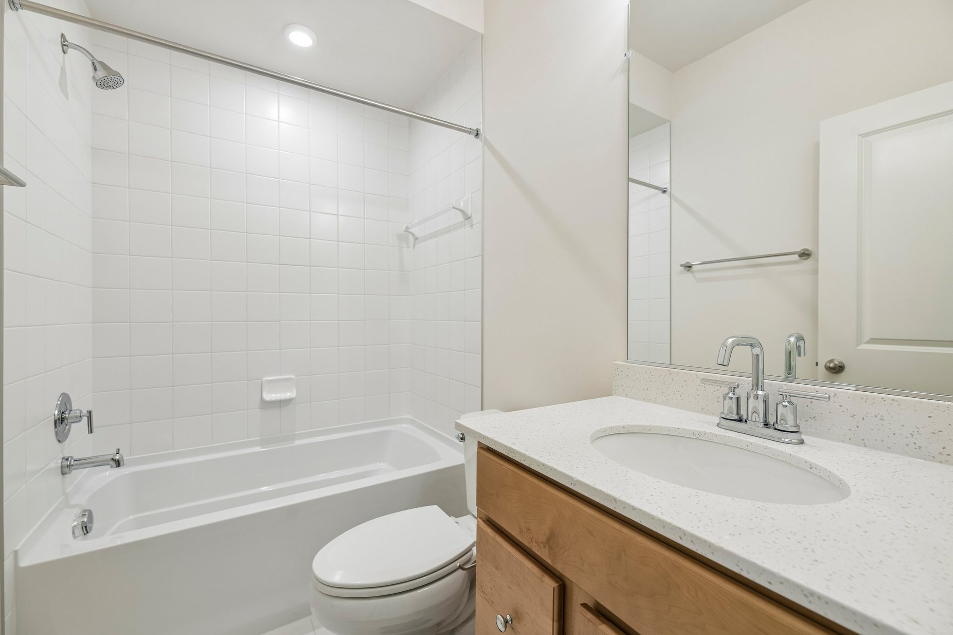 secondary bathroom with a shower and tub combo
