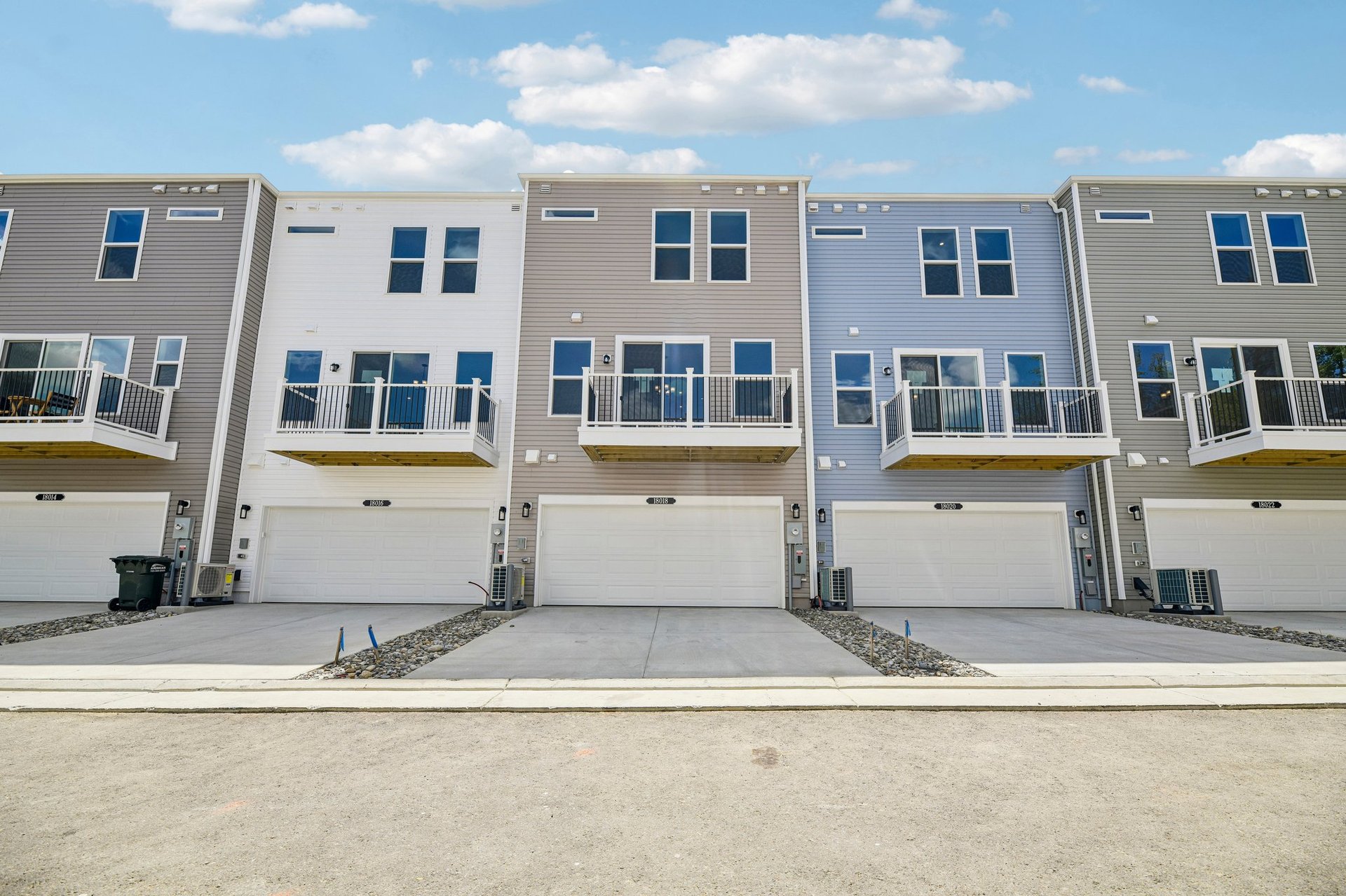 three story townhome rear exterior with a two-car garage