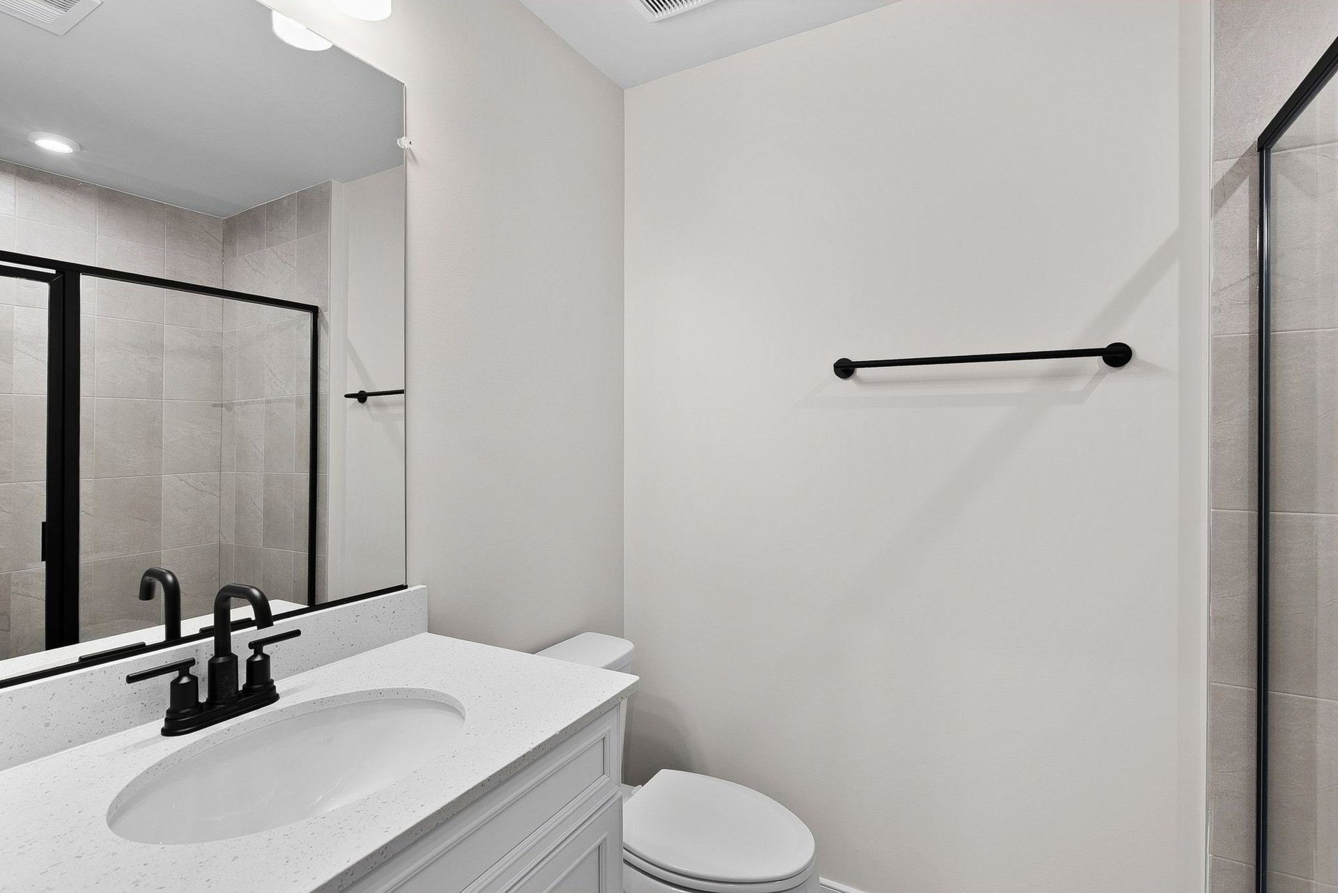 secondary bathroom with a walk-in shower