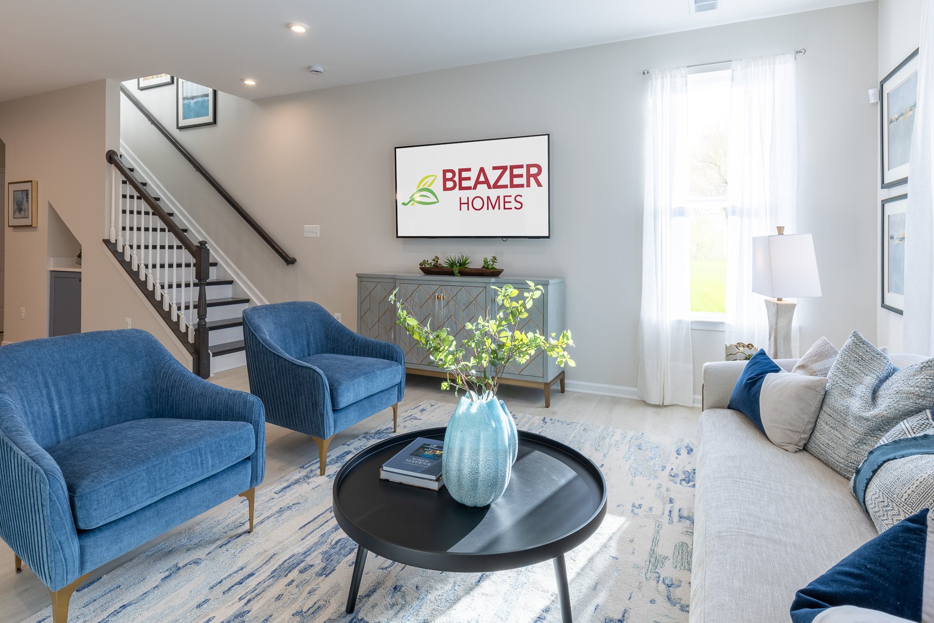 great room with blue velvet chairs and a couch
