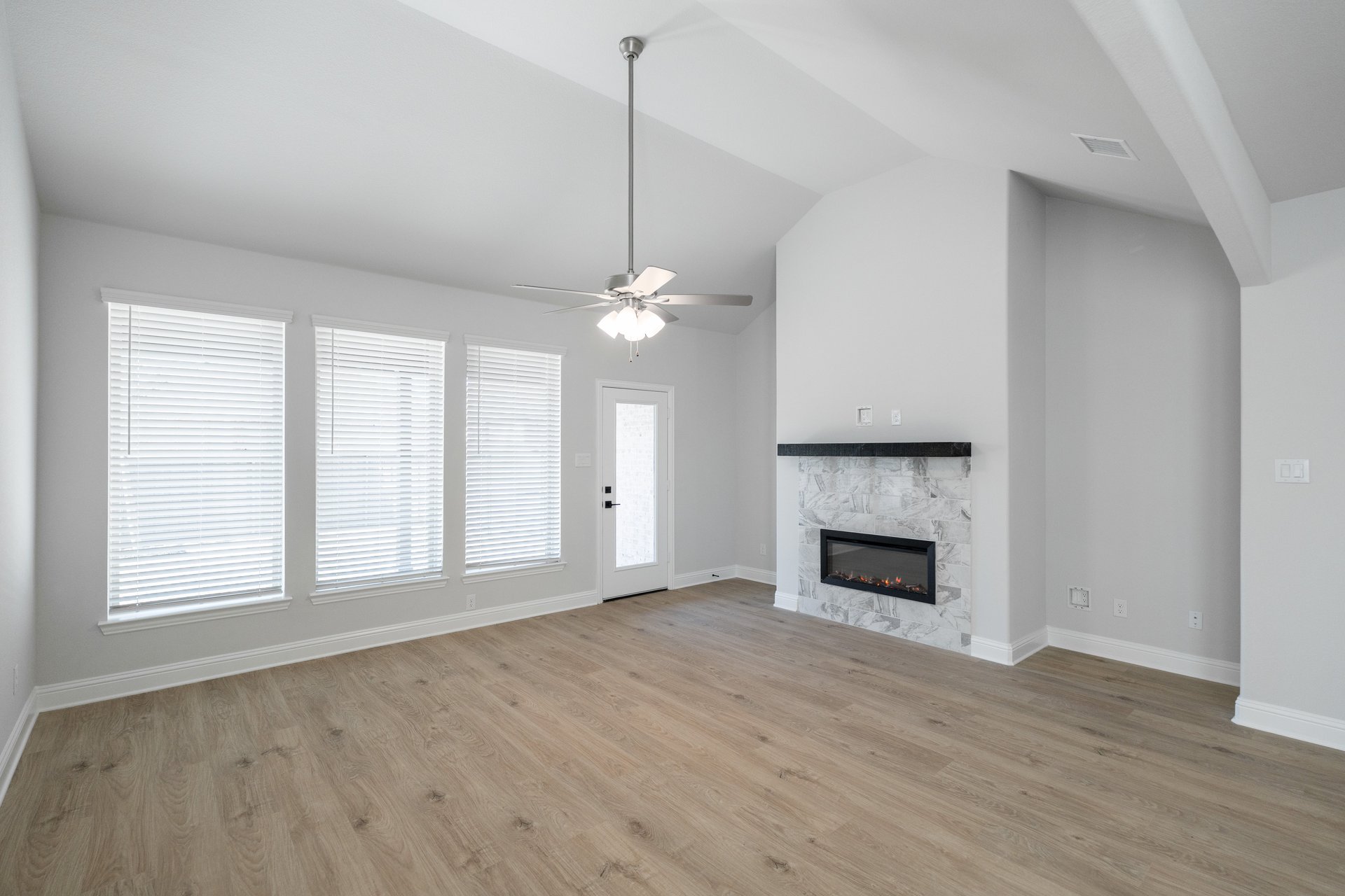 open great room with wood floors and fireplace