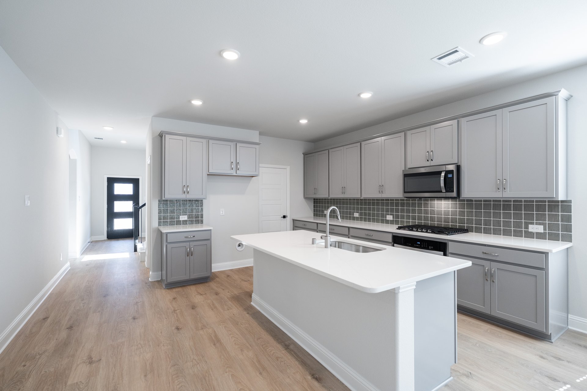 open kitchen with wood floors and island