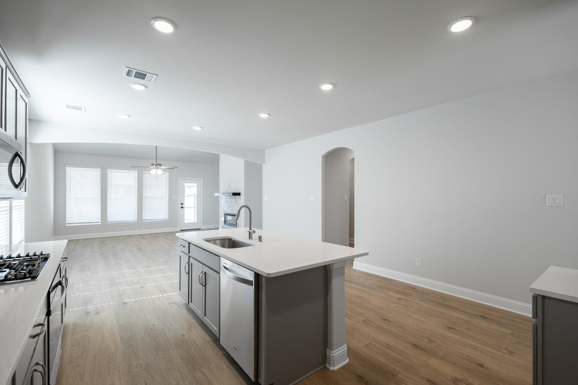 open kitchen with wood floors and island