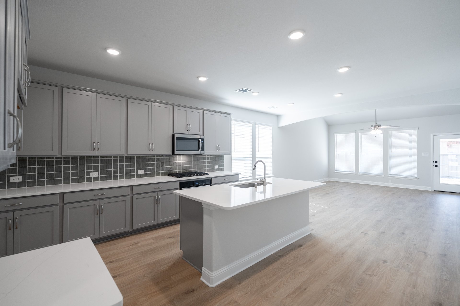 open kitchen with wood floors and island