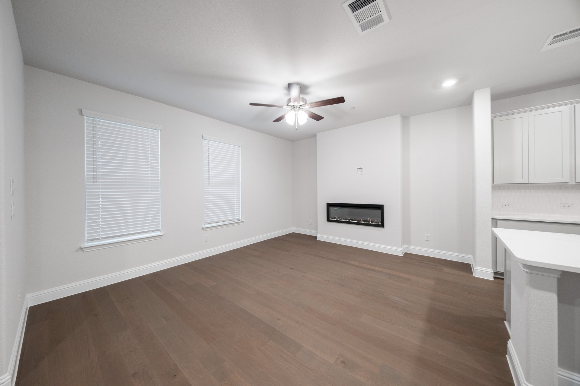 great room with wood flooring and fireplace 