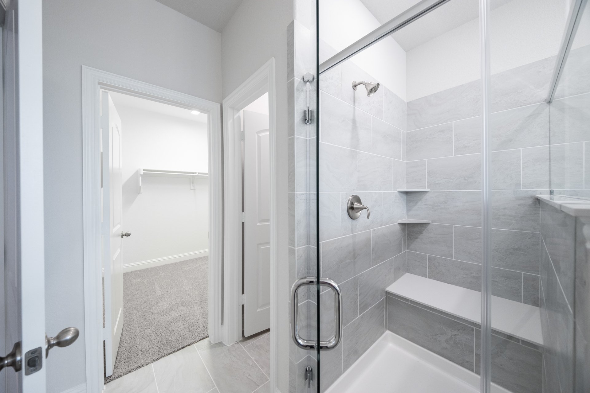 walk-in shower with glass doors and tile 