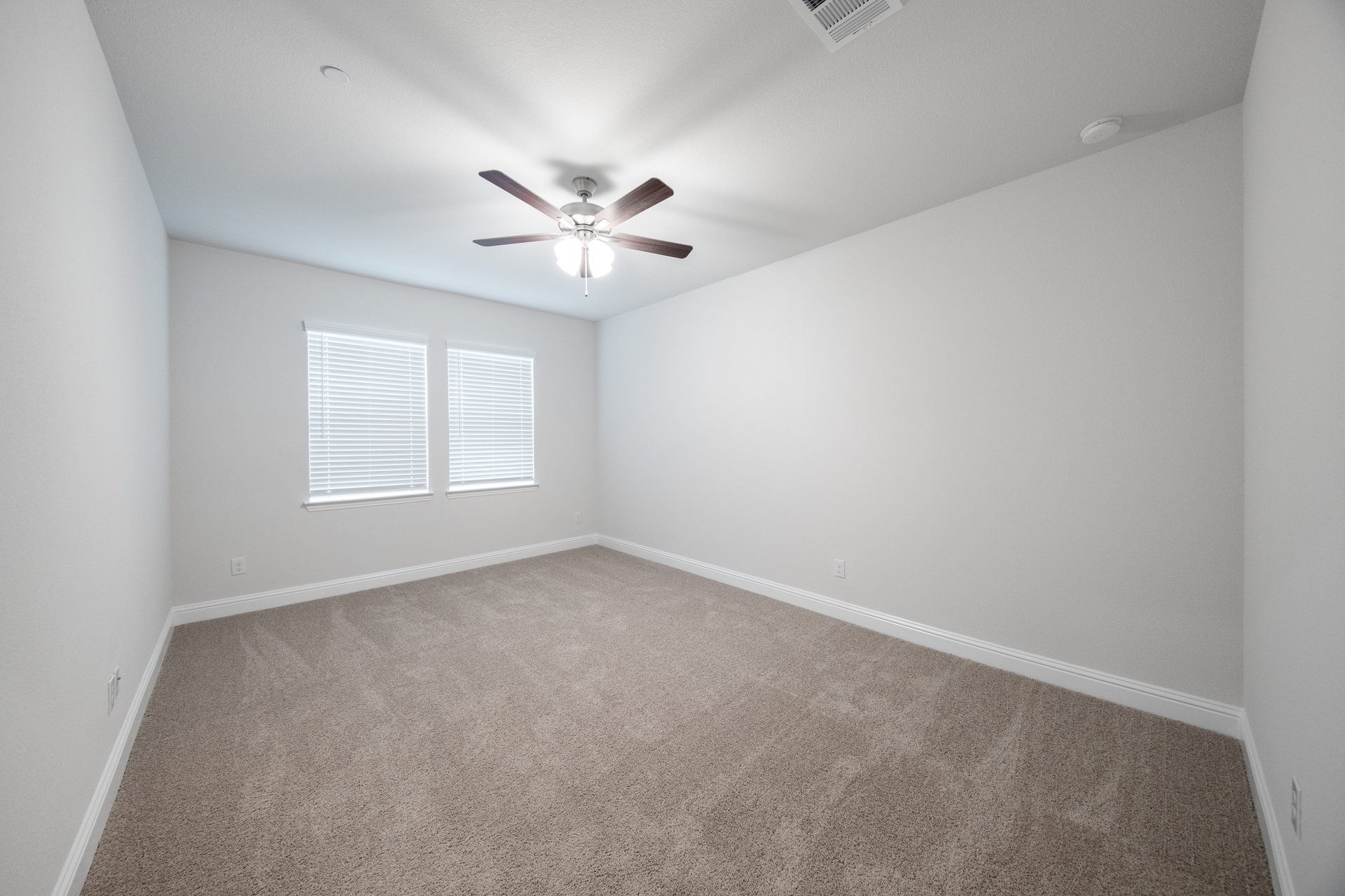 bedroom with carpet and windows with blinds 