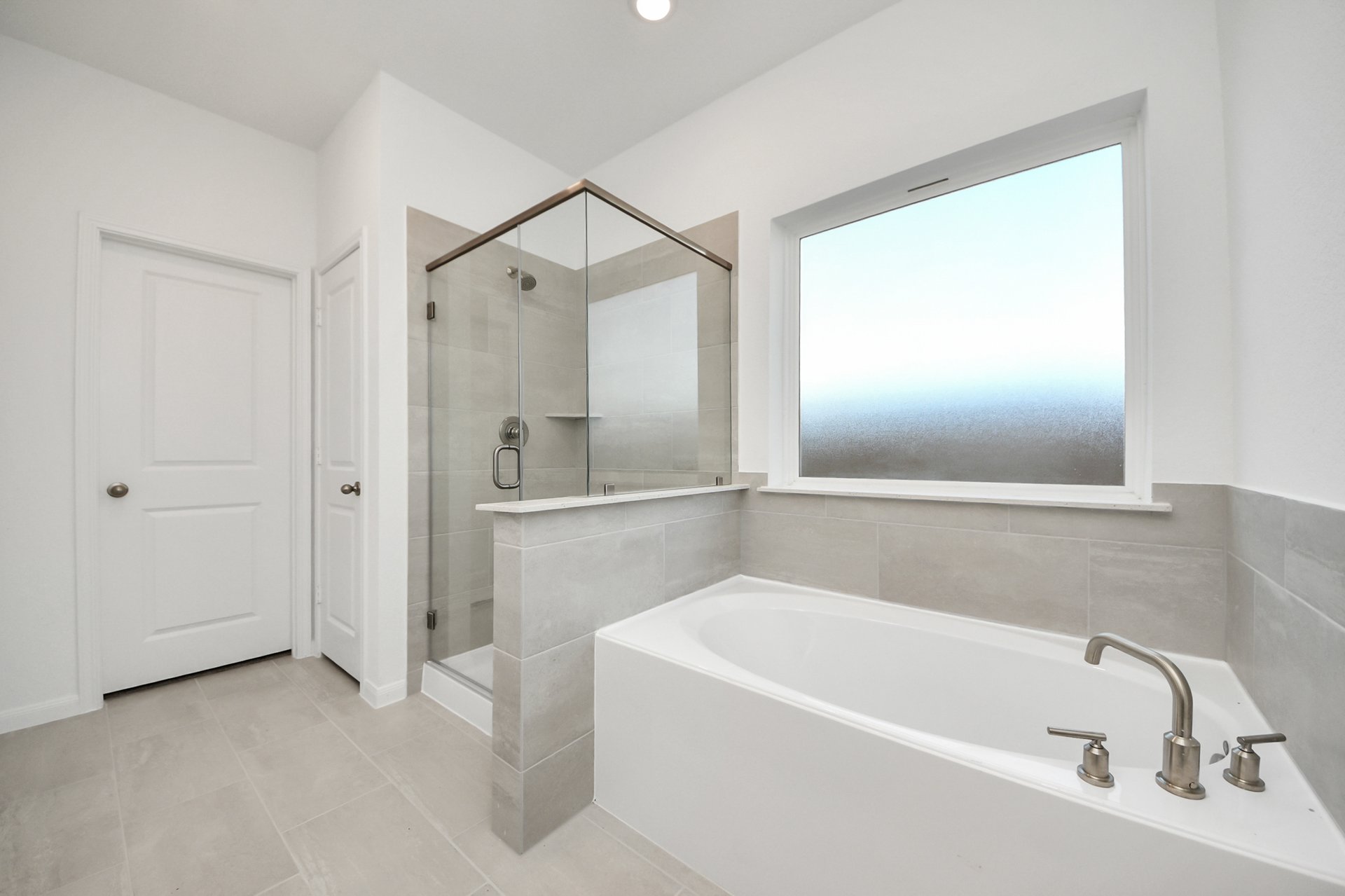 Primary Bathroom with a shower and tub.