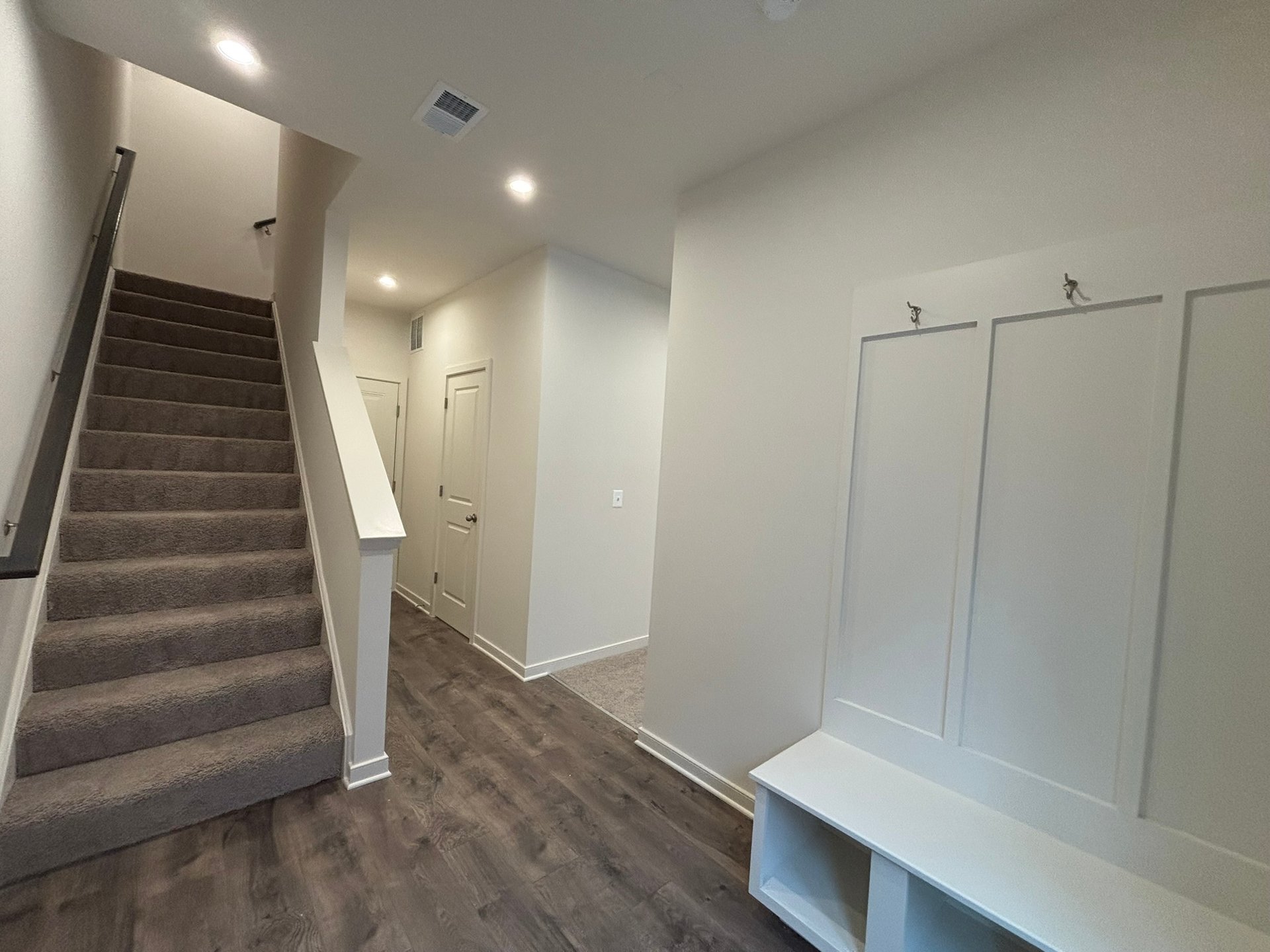 foyer with a bench with cubbies and hooks
