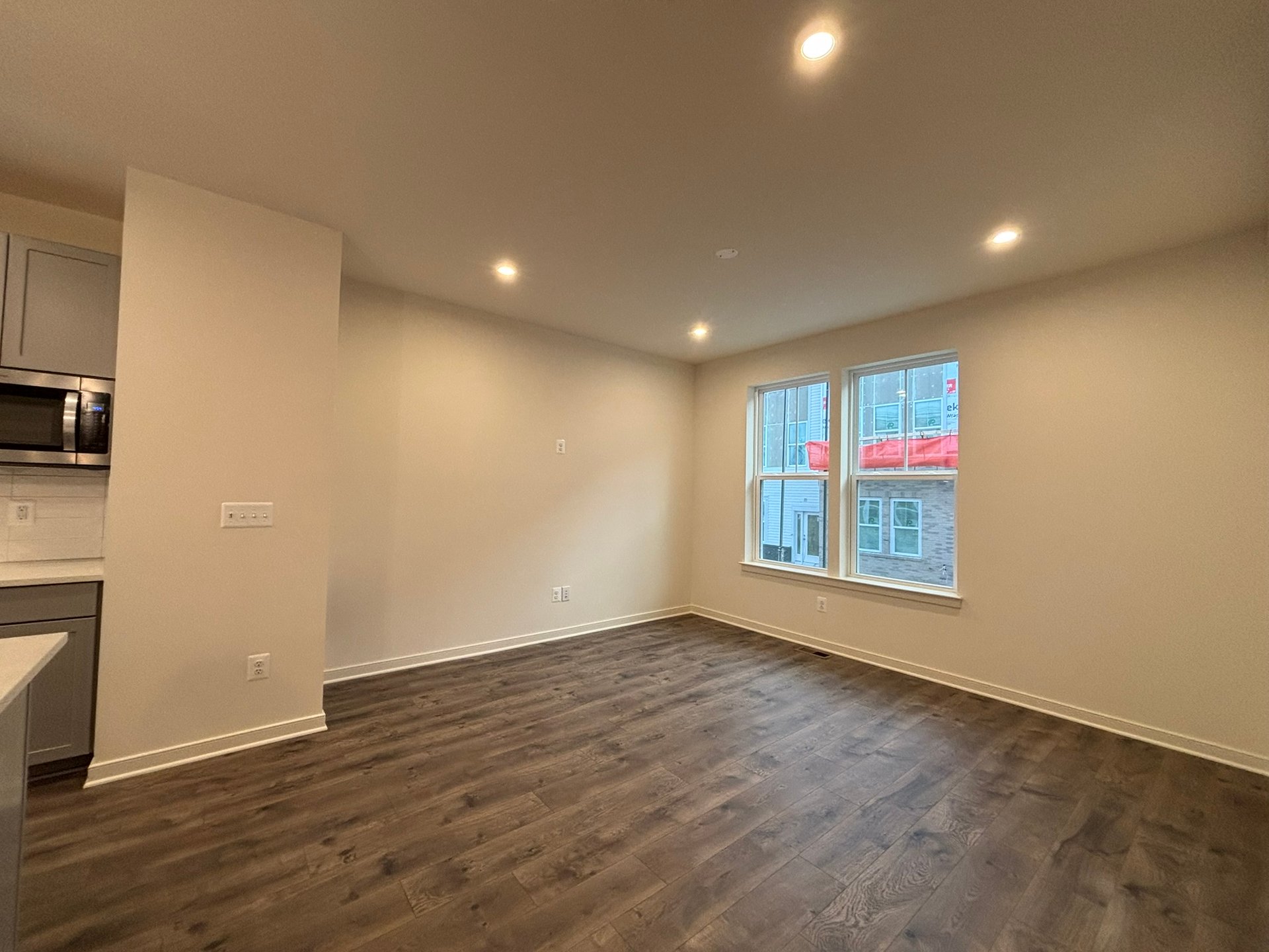 great room with access to kitchen and two windows