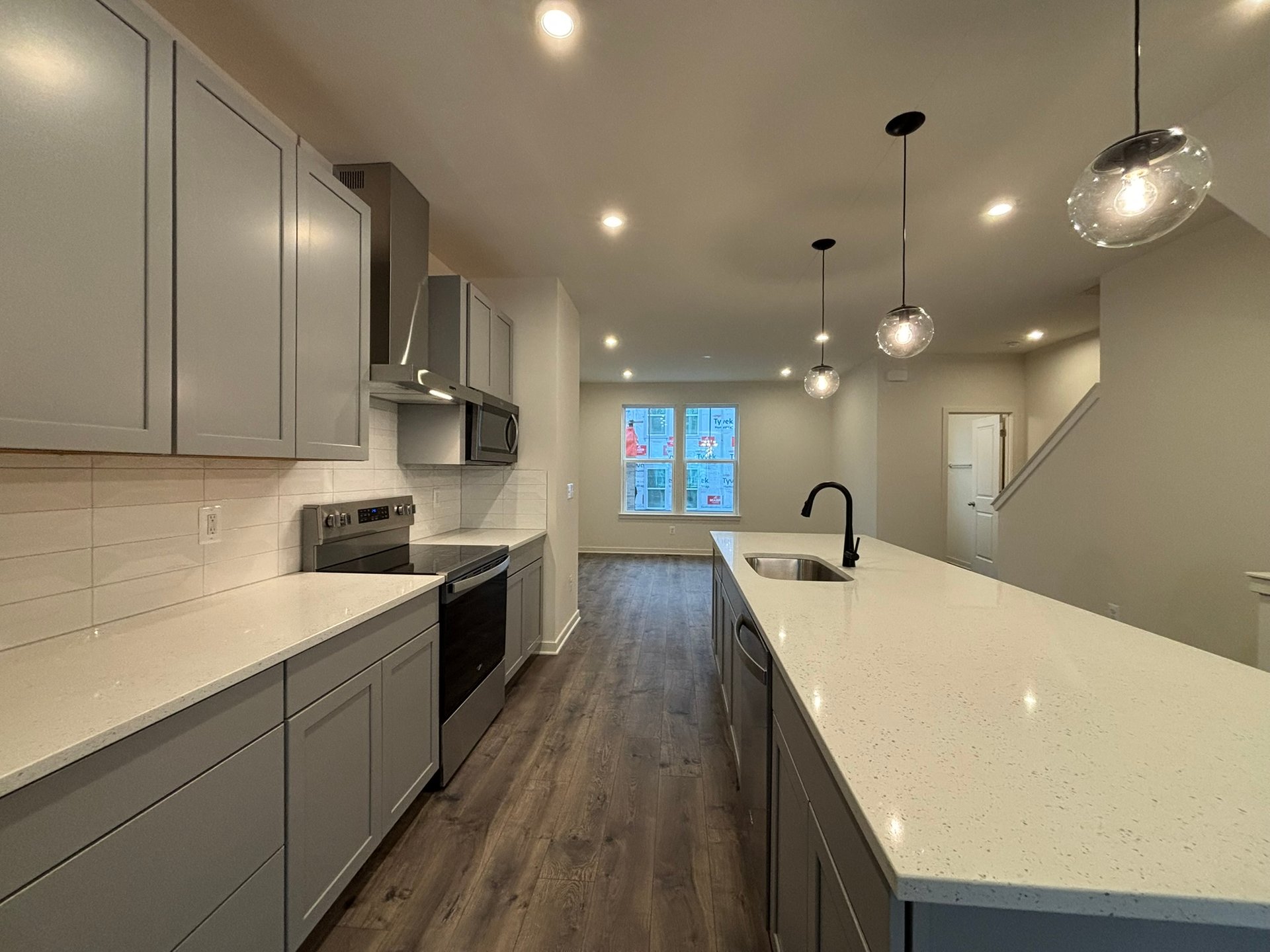 kitchen with white countertops and pendant lighting