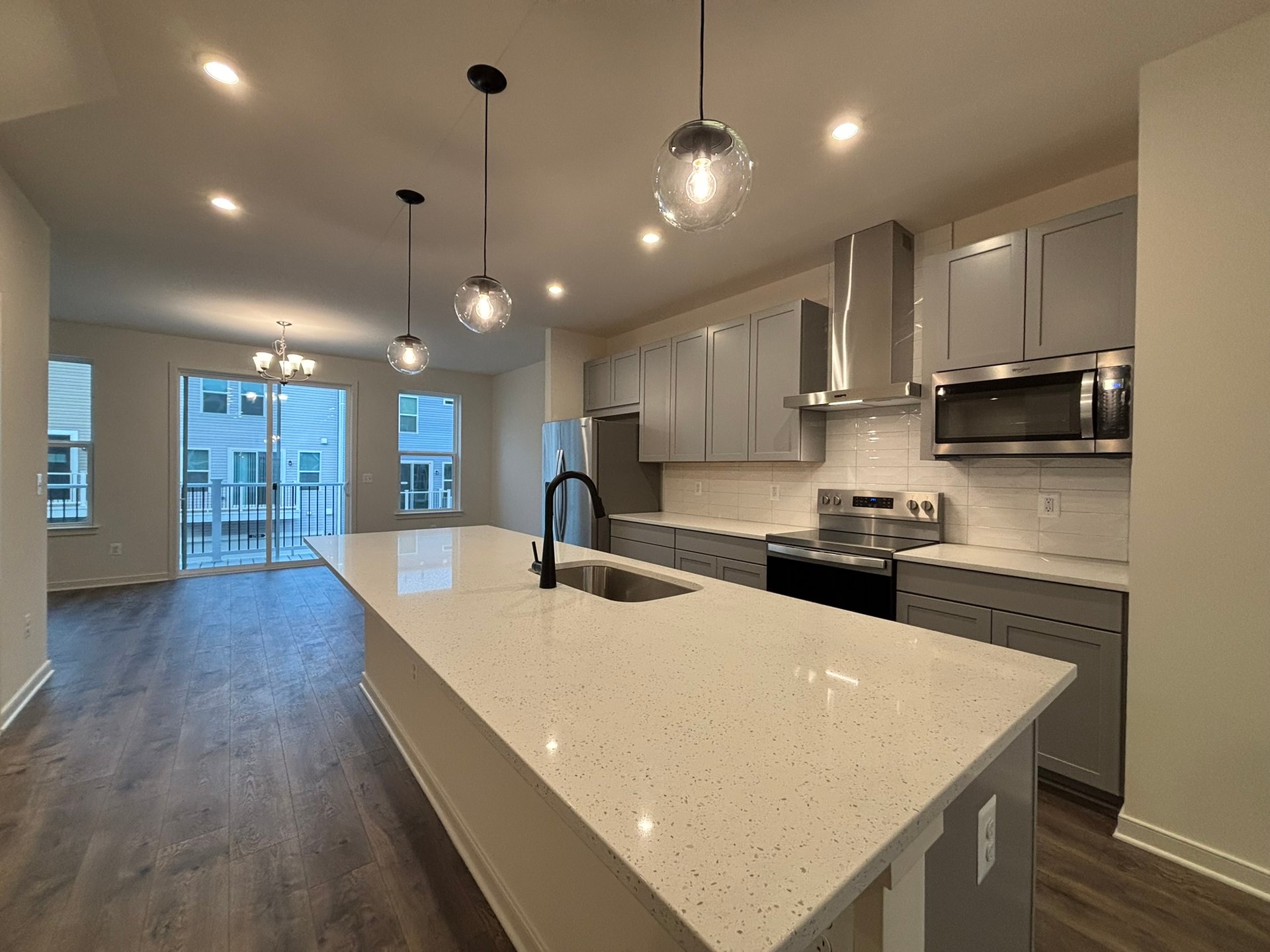 kitchen with an island with a sink and access to dining area