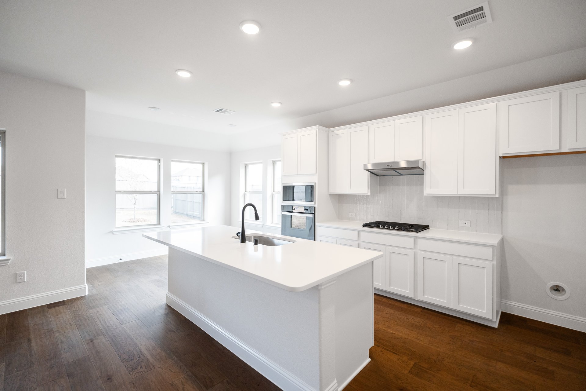 open concept kitchen with white cabinets