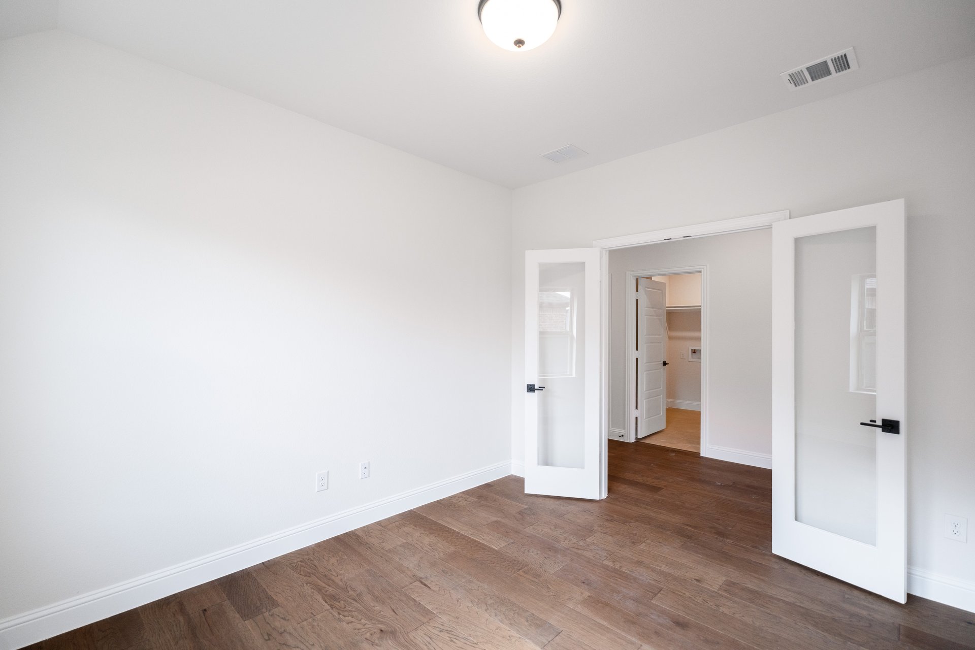 study room with french doors and wood flooring