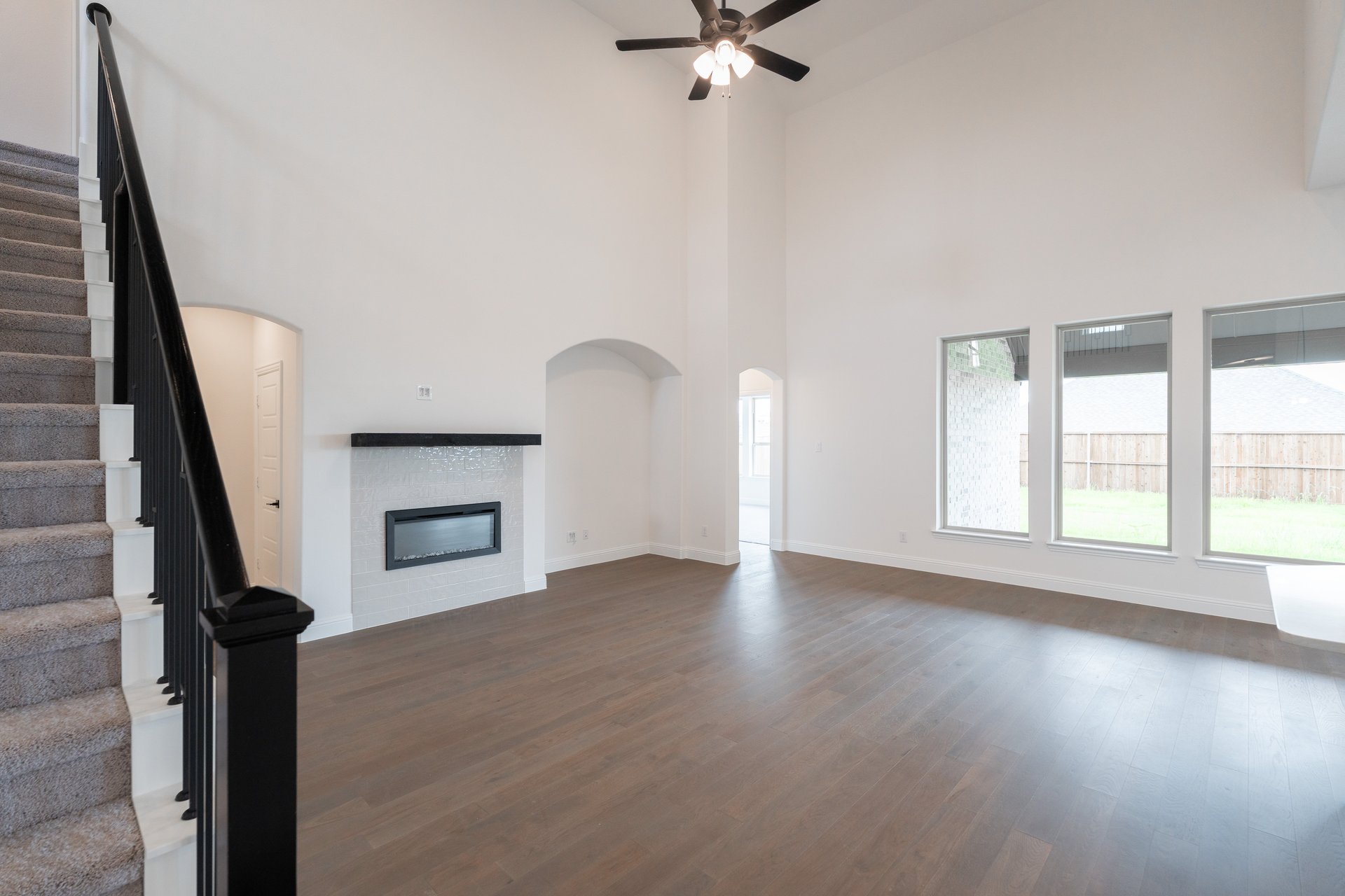open great room with wood floors and fireplace