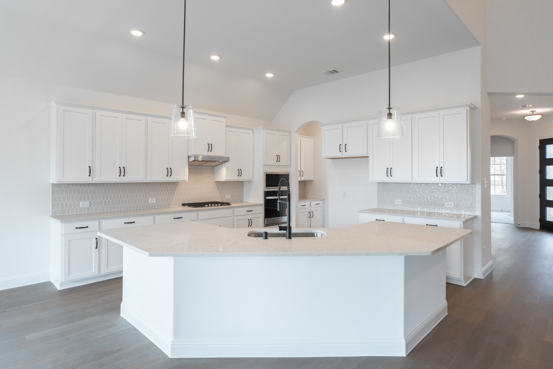 open kitchen with wood floors and island