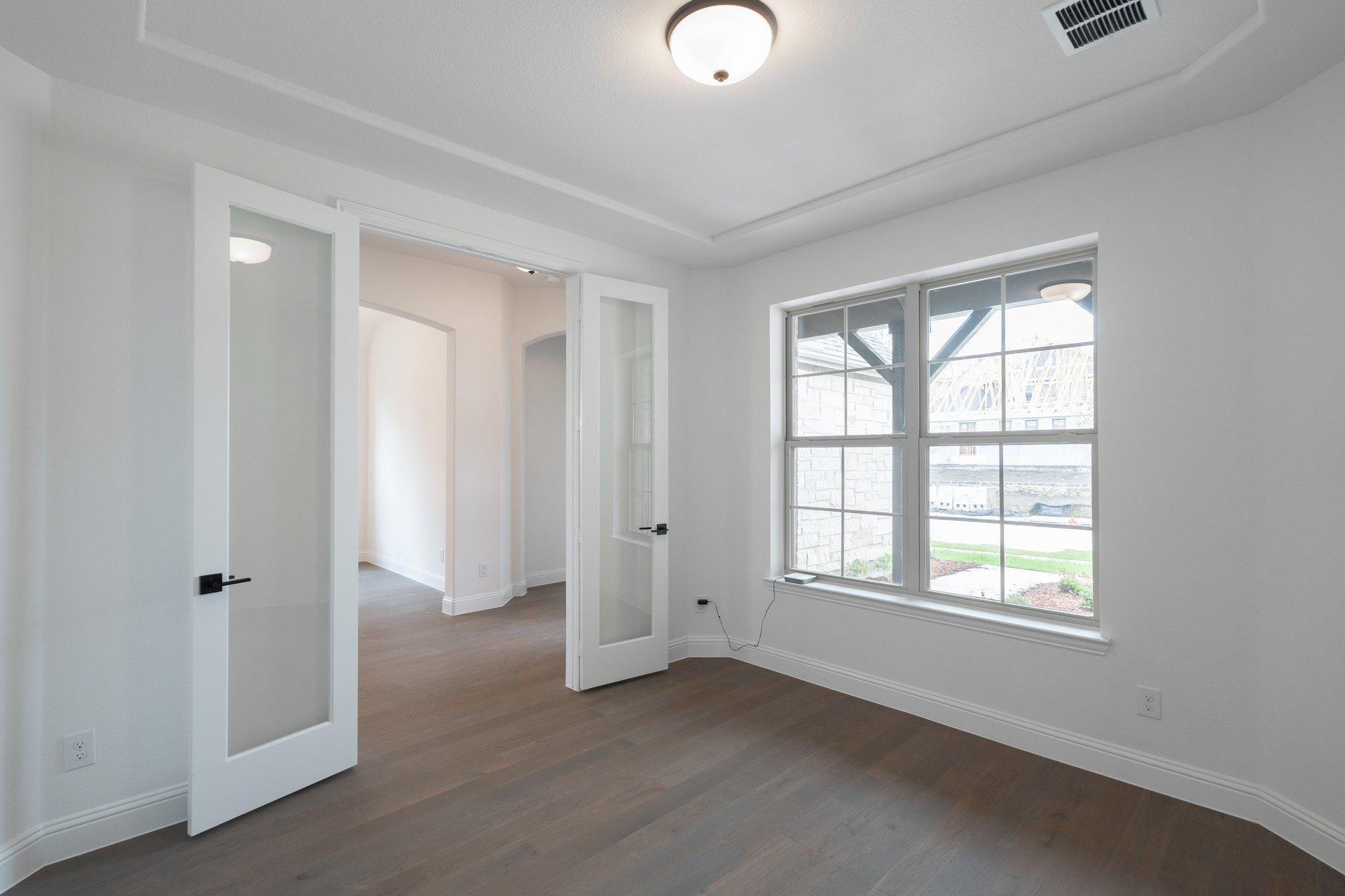 private study with wood floors and windows