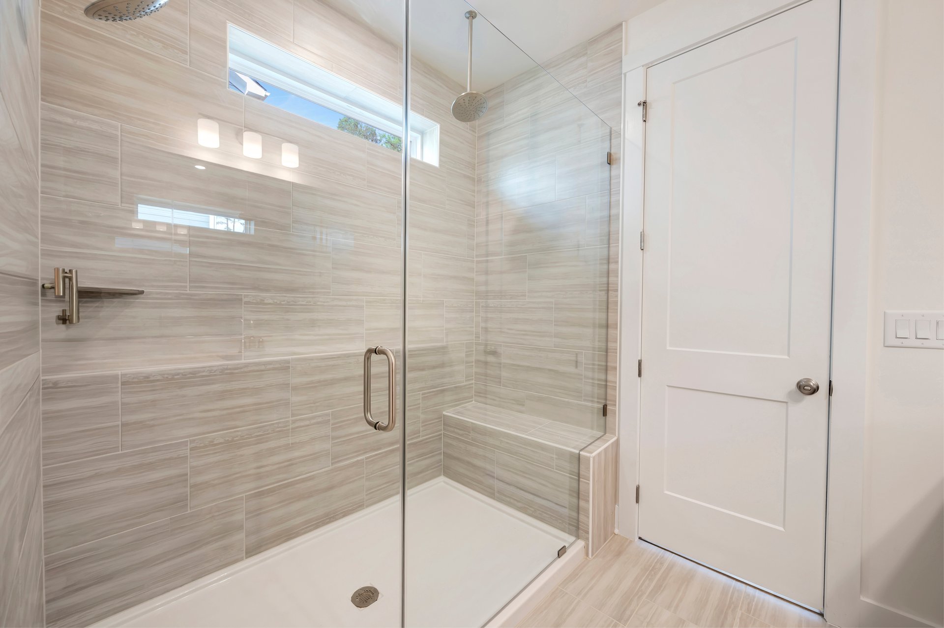 oversized shower with a seat and a window