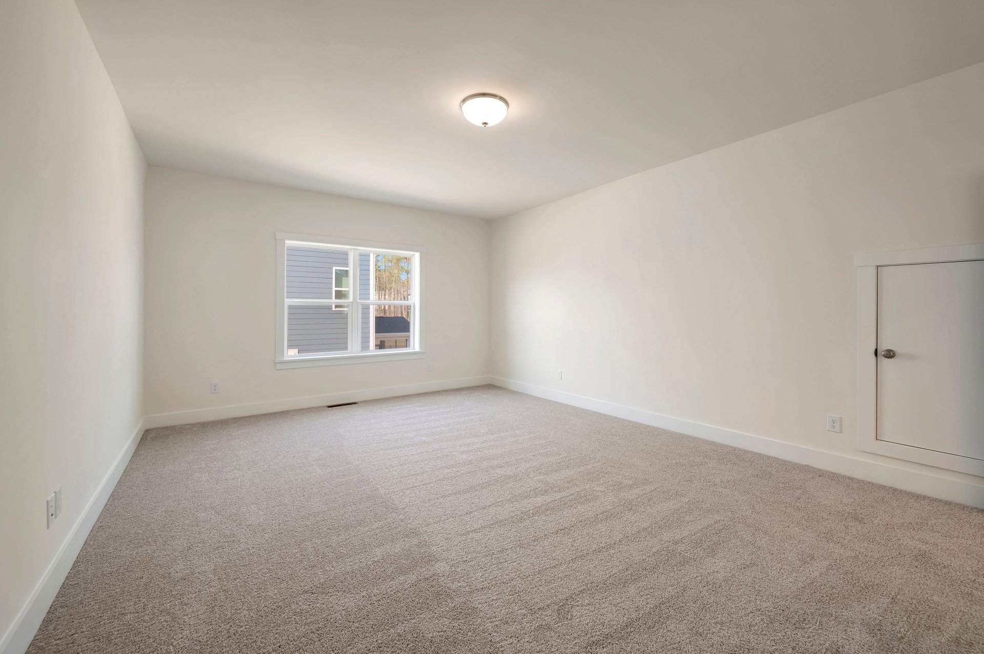 bonus room with carpet, two windows and a storage area