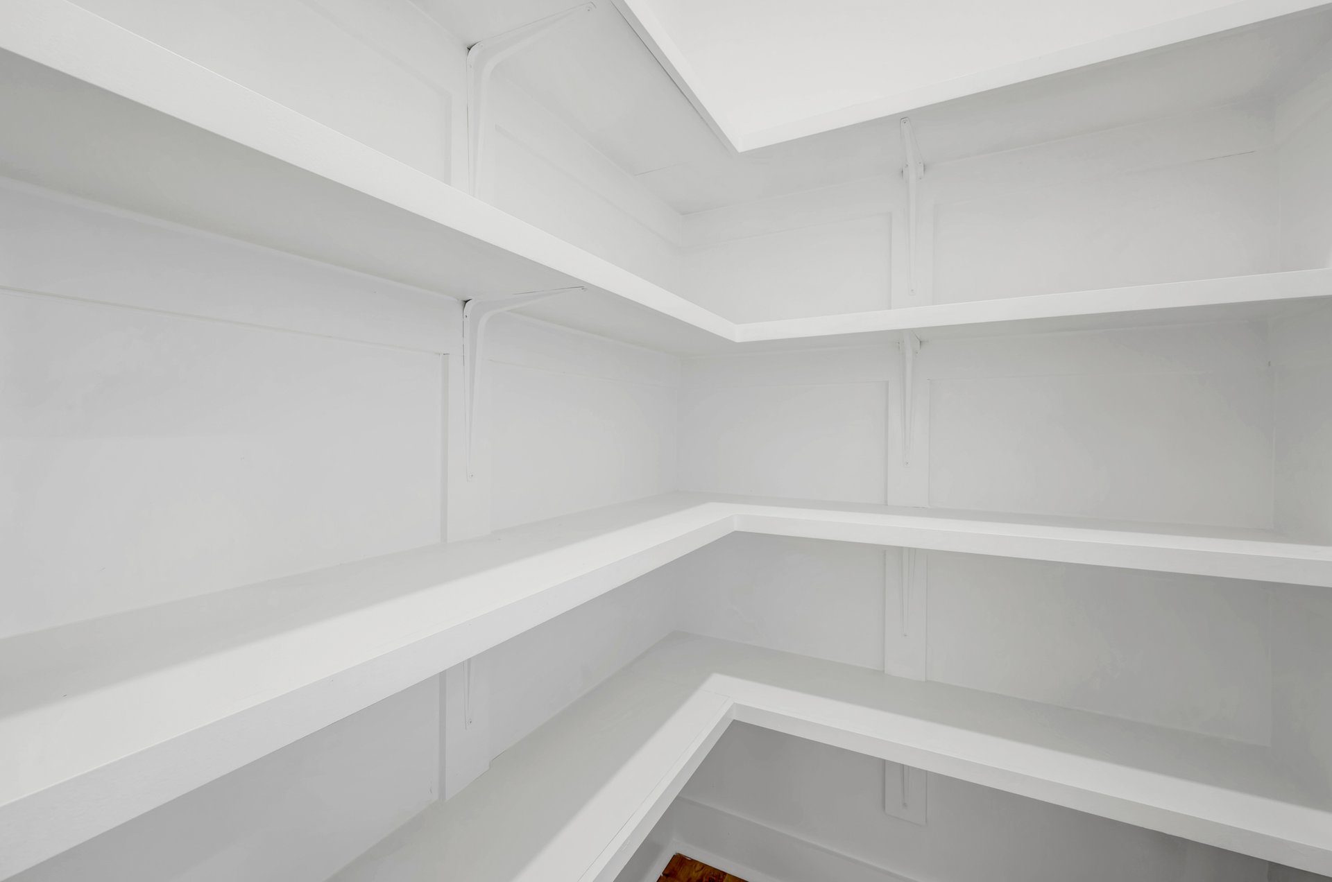 walk-in pantry with wooden shelves