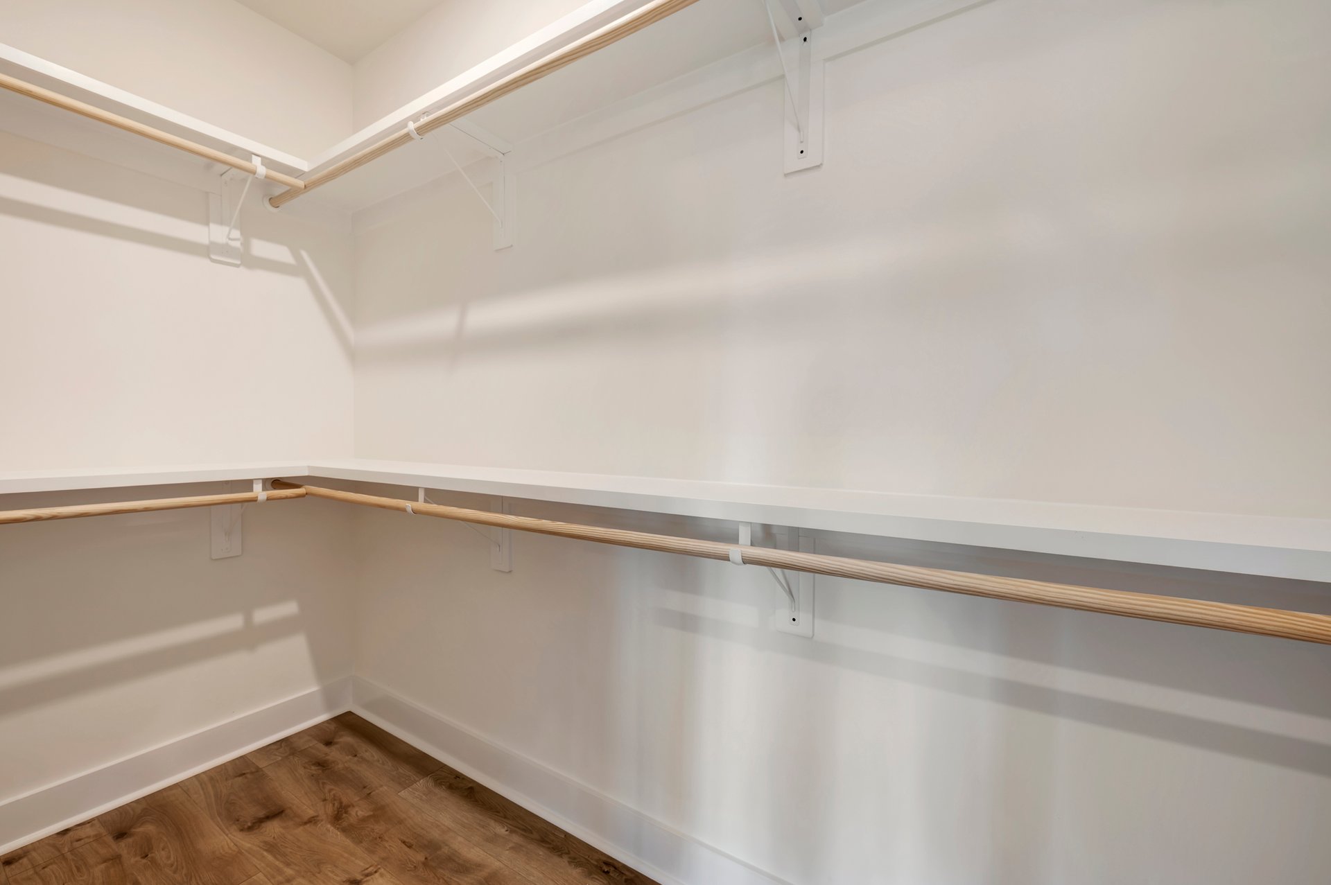 primary walk-in closet with wooden shelves