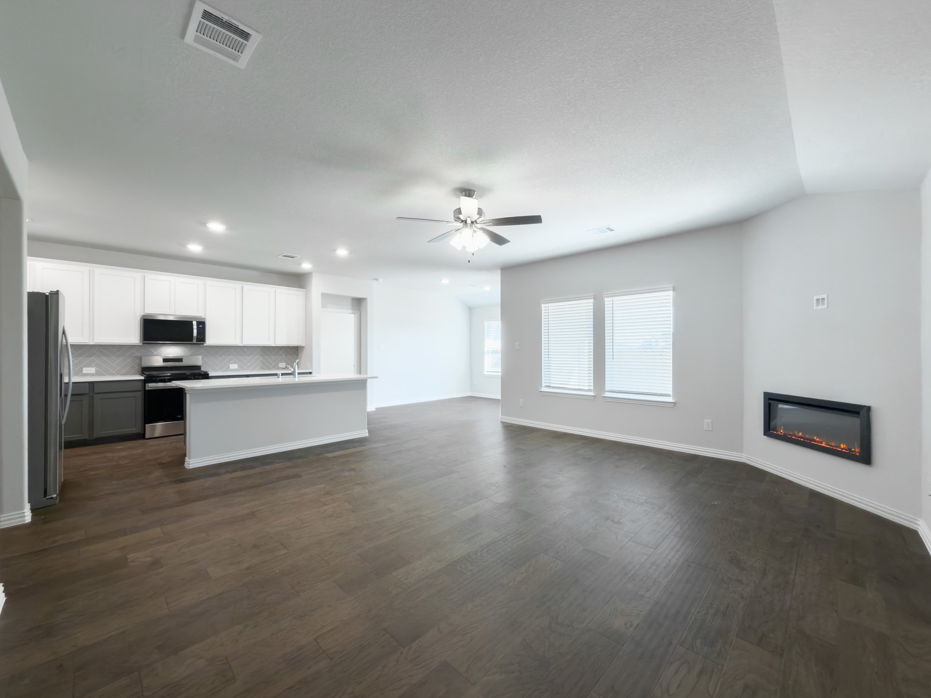 great room with wood flooring and electric fireplace