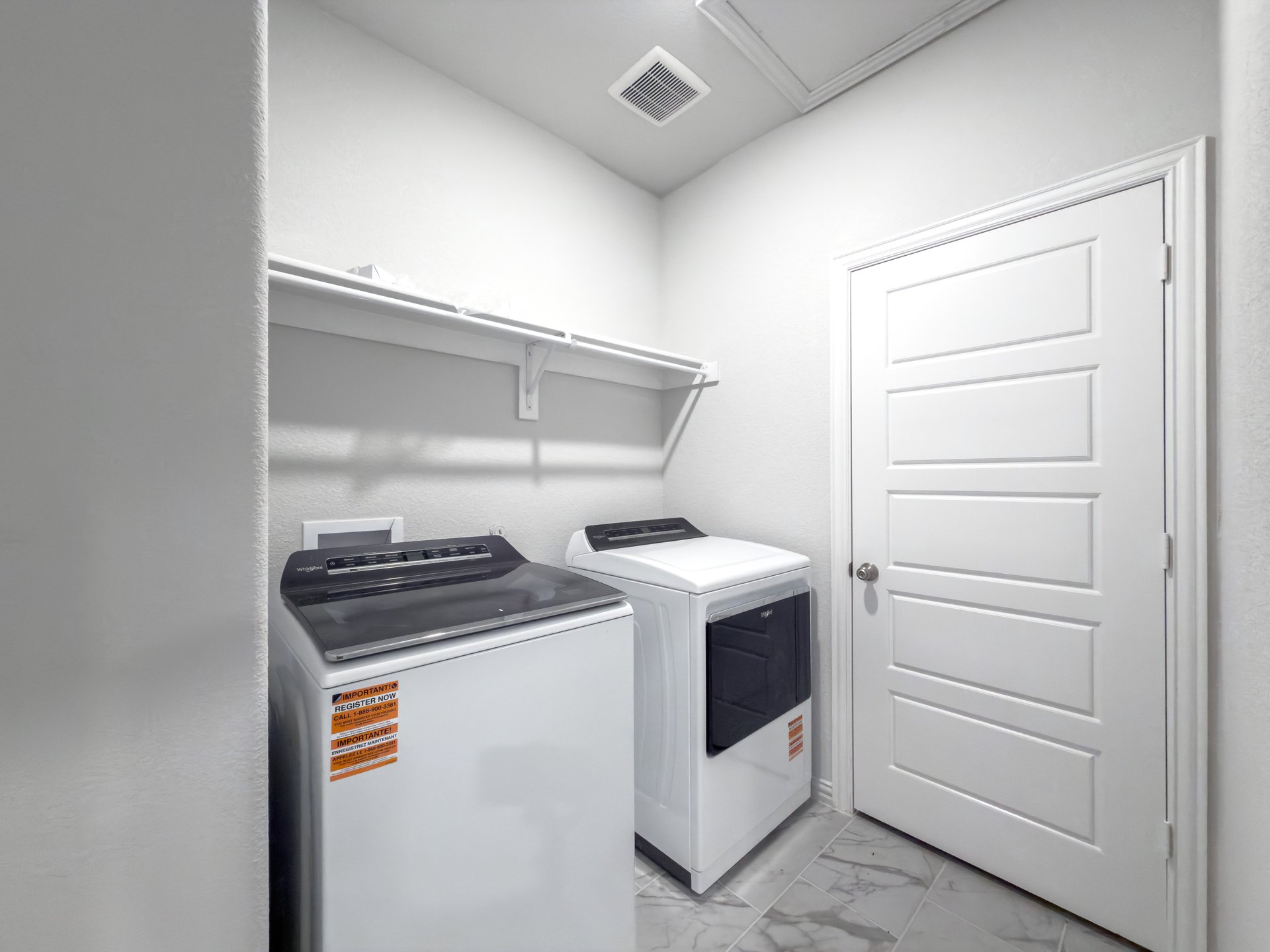 laundry room with washer dryer and a shelf