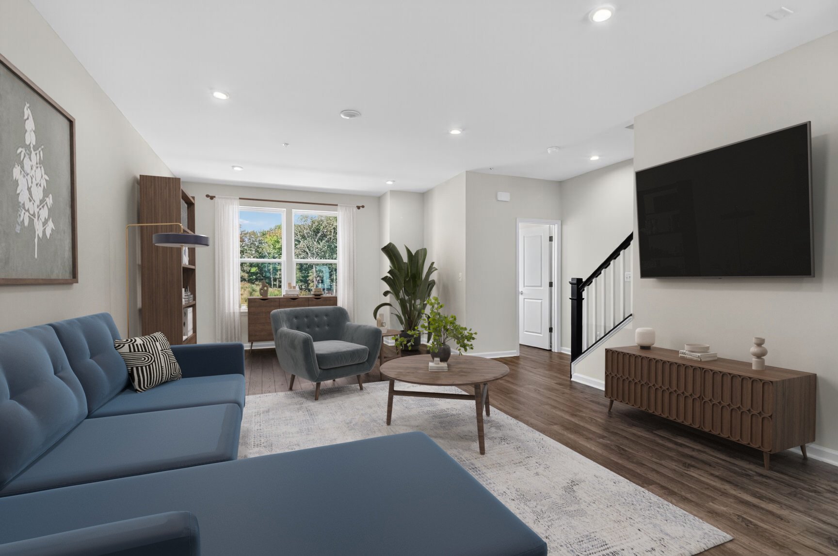 great room with a large couch and designer floors