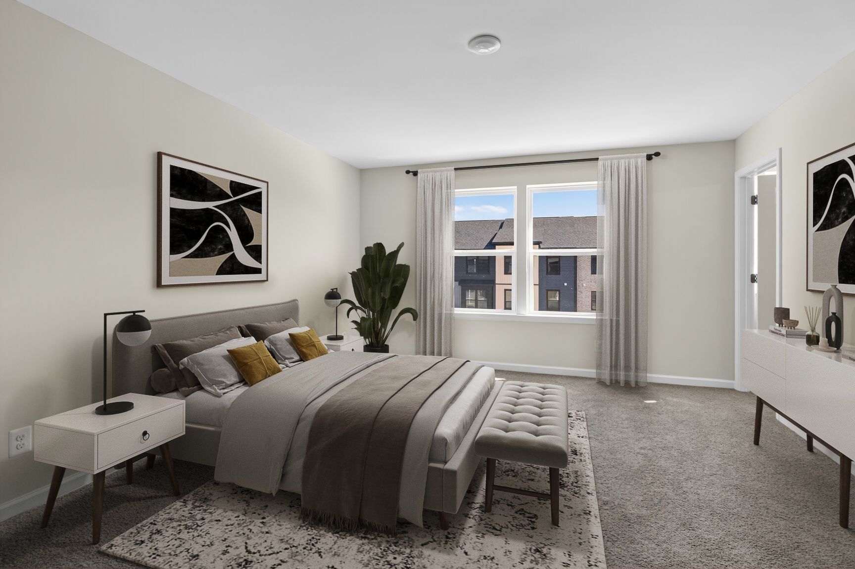 primary suite with a king-sized bed and multiple windows