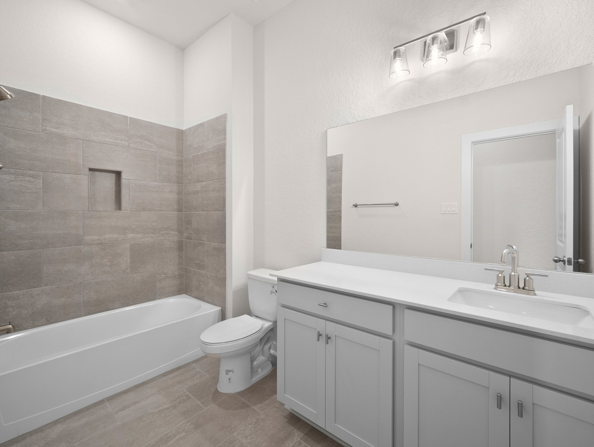 bathroom with soaking tub, quartz countertop & sink
