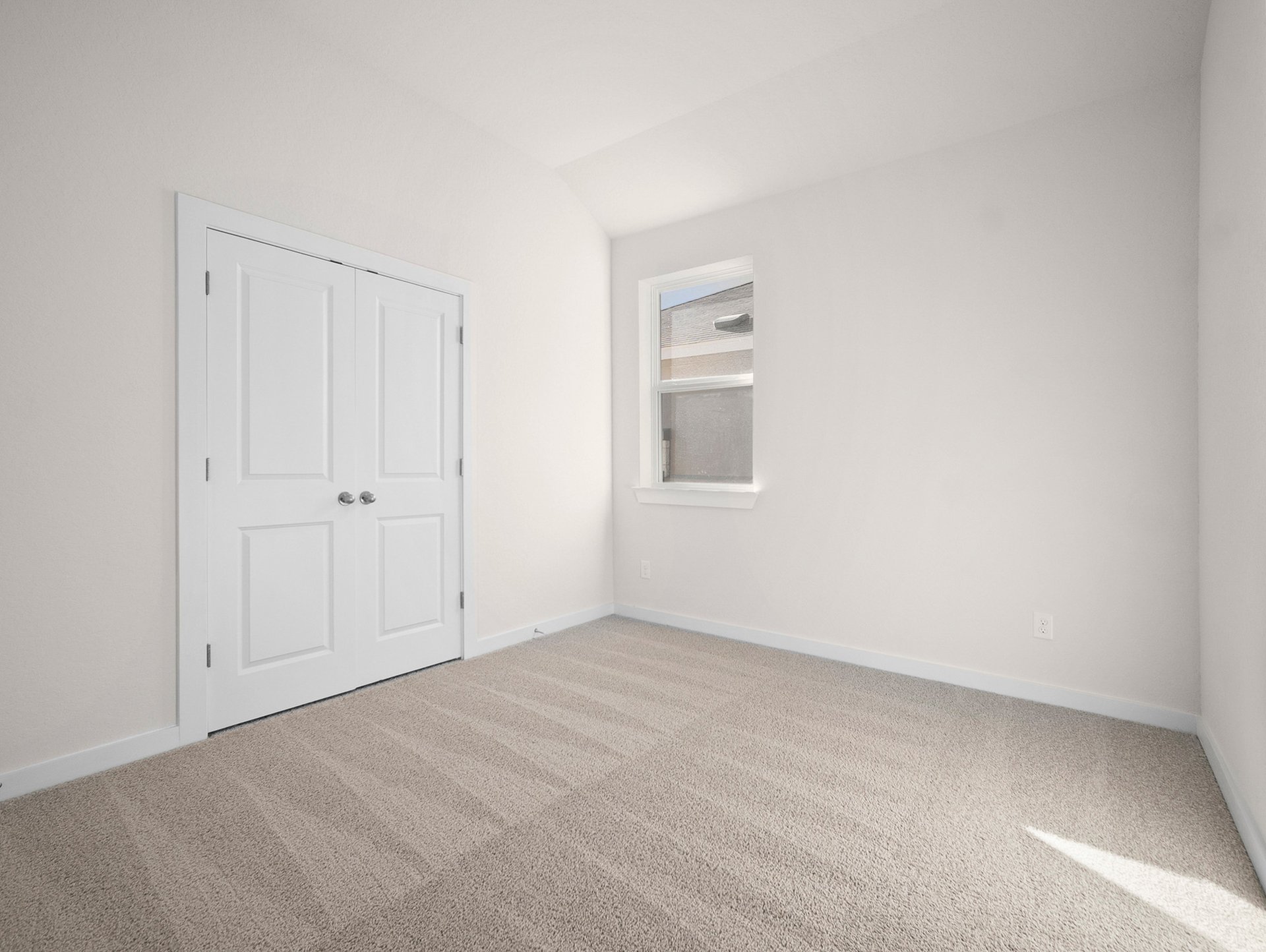 bedroom with carpet, window & a sloped ceiling
