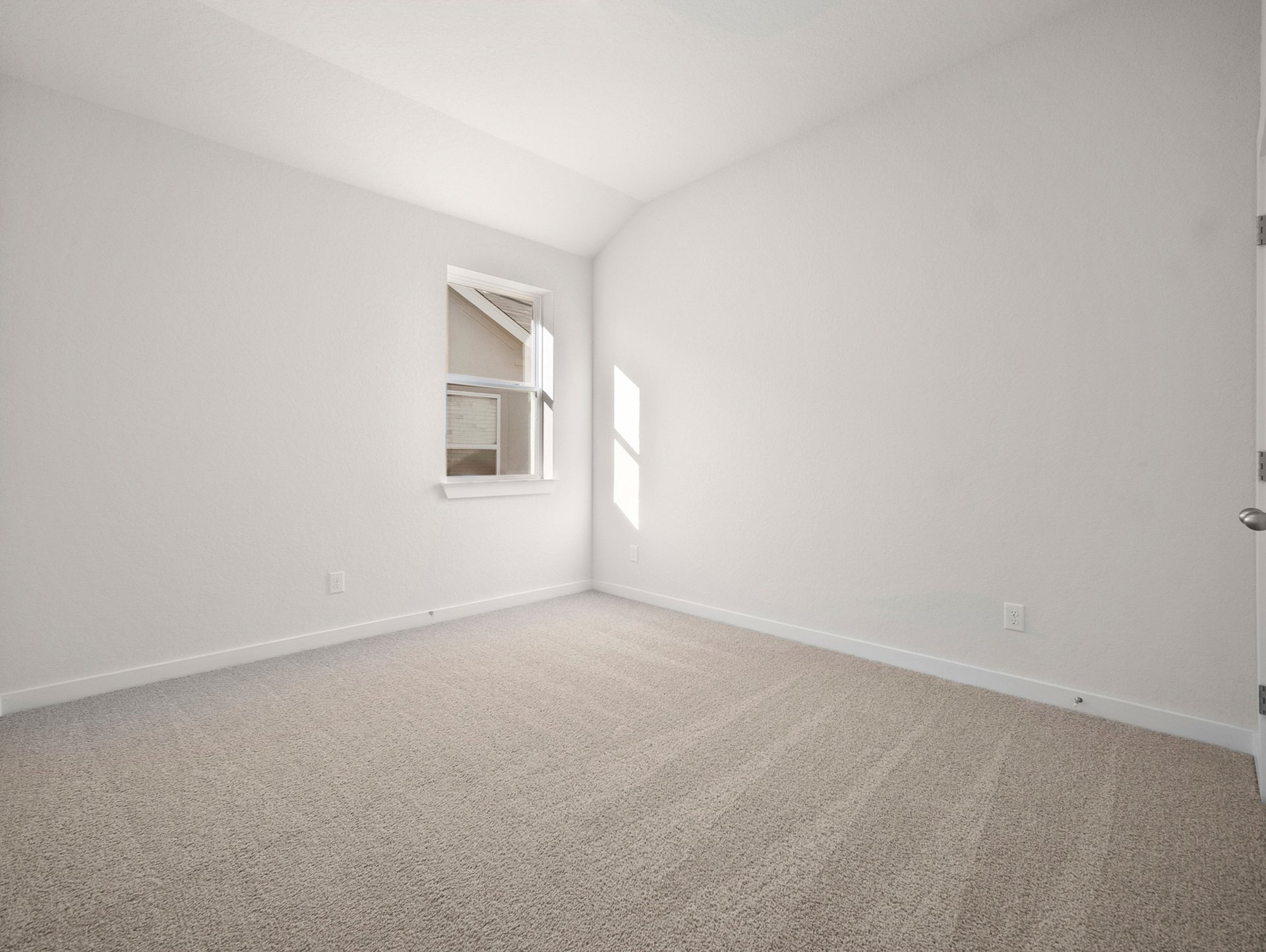 bedroom with carpet, window & a sloped ceiling