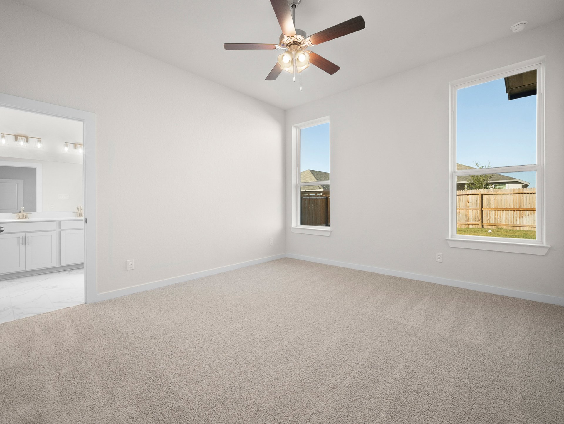 bedroom with carpet, ceiling fan & windows