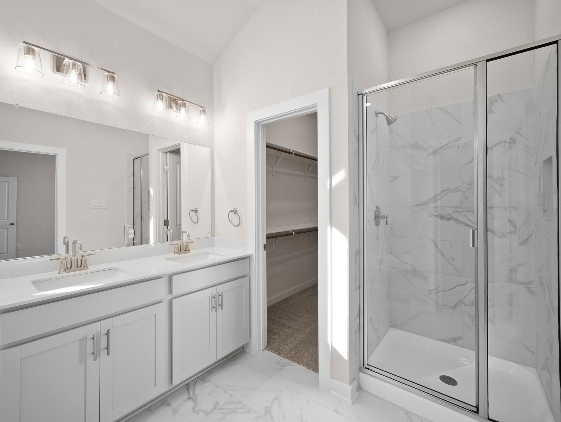 bathroom with dual sinks & walk-in shower