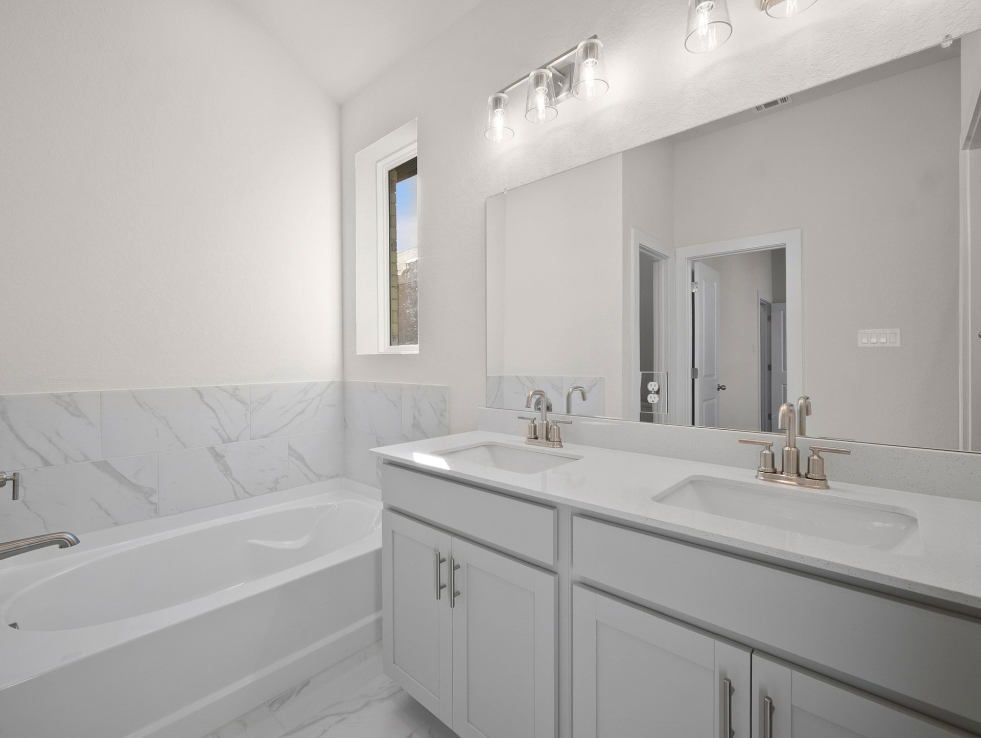 bathroom with dual sinks & soaking tub