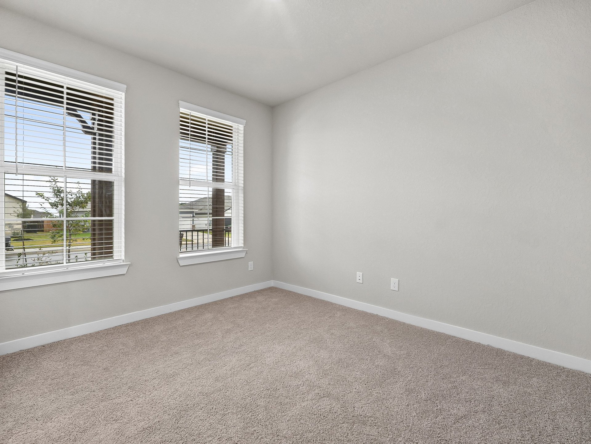 study with carpet, windows & recessed lighting