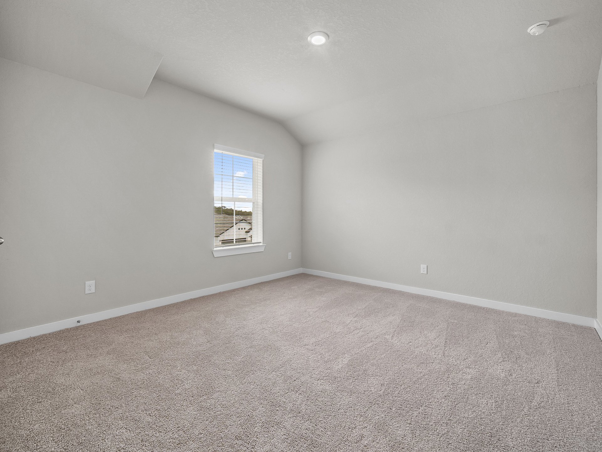 bedroom with carpet, window & a sloped ceiling